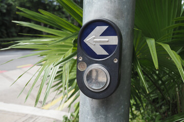Traffic signal button for pedestrians at a busy intersection