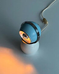 lamp glowing warmly with electric cord.