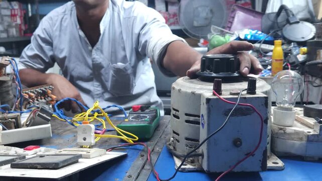 Electronics repair and maintenance service. technician mechanic working with parts in local shop in India, Odisha