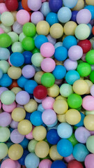 small, colorful, portrait-shaped toy balls