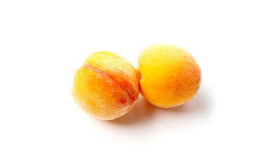 Fresh ripe apricots on a white background.