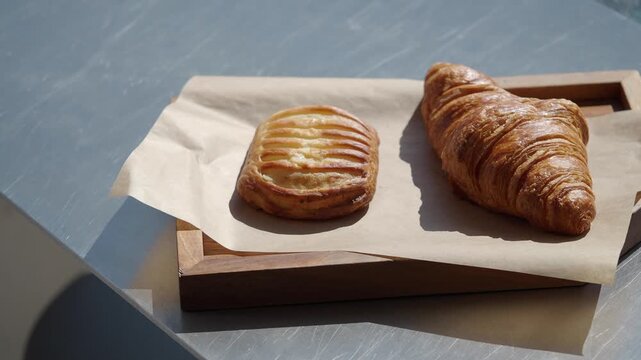 Freshly baked pastries on a wooden tray in a cafe