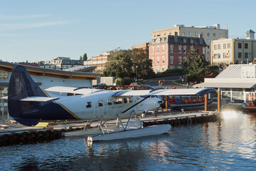 A seaplane docked at the harbor during sunset in Victoria, Vancouver Island, Canada.