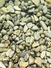 natural background of smooth sea stones underwater

