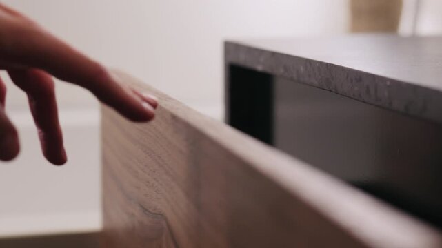 Slow motion man hand open and close batroom cabinet drawer closeup