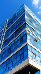 Fototapeta premium Modern glass office building against a blue sky