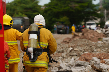 Firefighters are working together to put out the fire with water.