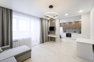 modern apartment interior with an open floor plan featuring a living area and a kitchen