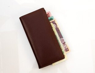 Brown Leather Wallet with Colorful Afghanistan Banknotes on White Background