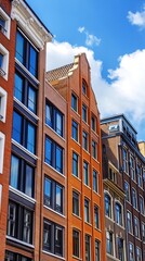 Fototapeta premium Row of colorful historic buildings with modern accents under a partly cloudy sky