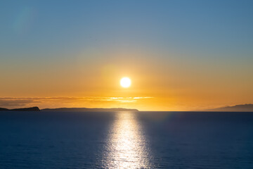 Winter sunrise over the ocean at Long Bay, Auckland