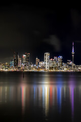 Auckland city skyline at night with harbor reflections (Vertical)