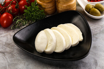 Organic mozzarella cheese slices in the plate