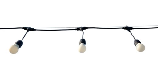 Vintage glowing light bulbs hang from a thin wire in the air