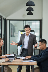 Group of Asian business people meeting and presenting work in the office	