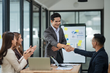 Asian business group is happy to join hands to show success in their careers.	