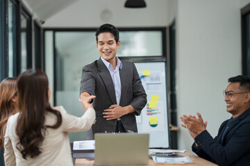 Asian business group is happy to join hands to show success in their careers.	