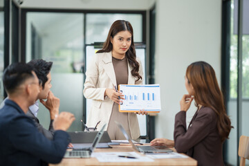 Group of Asian business people meeting and presenting work in the office	