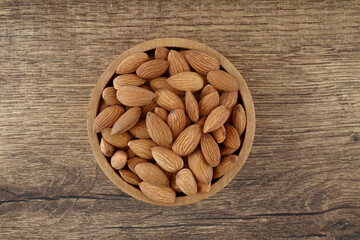 Close up of fresh almonds in wooden bowl
