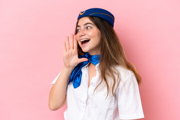 Airplane stewardess caucasian woman isolated on pink background shouting with mouth wide open to the lateral