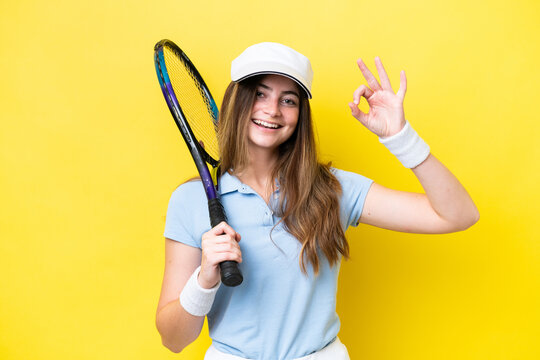 Young caucasian woman isolated on yellow background playing tennis and making OK sign - Powered by Adobe