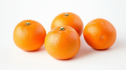 Four Ripe Mandarin Oranges On A White Surface