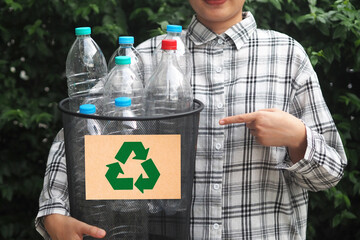 Woman hand holding bucket with plastic bottles for recycle. Reuse, Reduce, Recycle concept.