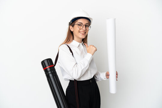 Young architect woman with helmet and holding blueprints isolated on white background proud and self-satisfied