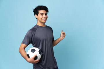 Venezuelan football player man over isolated background pointing back