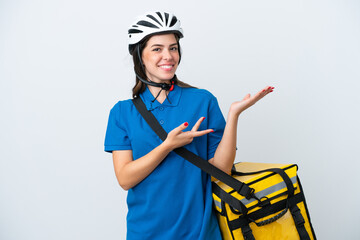 Young delivery woman with thermal backpack isolated on white background extending hands to the side for inviting to come