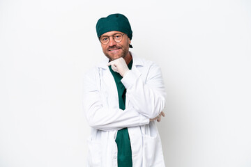 Middle age surgeon in green uniform isolated on white background with glasses and smiling