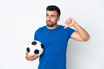 Handsome young football player man over isolated wall showing thumb down with negative expression