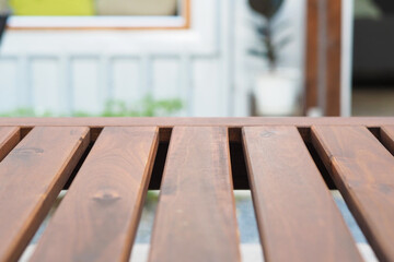 Empty wooden table top on blur background outside the house.  used for montage or display your products.