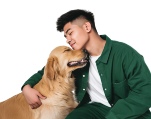 Young man hugging a golden retriever dog in a studio setting