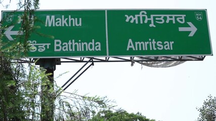 Sign board in India, Punjab showing Bhatinda and Amritsar directions. 