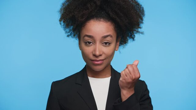 Playful woman making money gesture with fingers