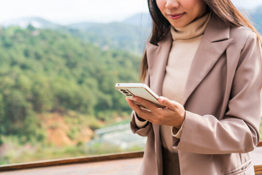 Smart businesswoman using mobile phone. Technology, lifestyle and work from anywhere concept