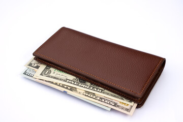 Brown Leather Wallet with U.S. Dollar Bills in Multiple Denominations on White Background