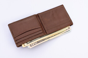 Open Leather Wallet Filled with US Dollar Banknotes on White Background.