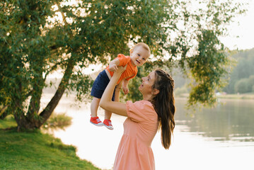 Obraz premium Mother And Baby Smiling By The Lake