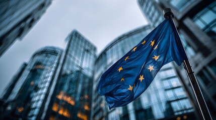 A close-up view of the European Union flag waving in the breeze, set against a backdrop of modern glass buildings and a dramatic sky, symbolizing unity, progress, and collaboration in Europe.