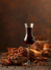 Coffee liquor with ingredients on a brown background.