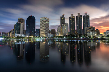 Bangkok Skyline with skyscrapers reflections taken at sunrise from Benjakitty Park
