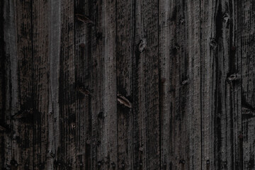 The exterior wall of a house made of black wooden planks in Yatsushiro city, Japan.