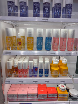Thessaloniki, Greece - august 09, 2025: various sol de janeiro branded beauty products, including body creams, mists, and sprays in yellow, pink, and blue bottles