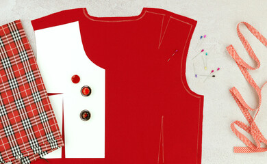 The panorama shows the modeling of clothes and the sewing process. Red fabric, a drawing of the...