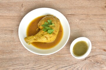 baking chicken tight and leg with herb on plate dipping spicy and sour chili sauce in cup