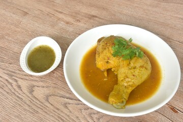 baking chicken tight and leg with herb on plate dipping spicy and sour chili sauce in cup