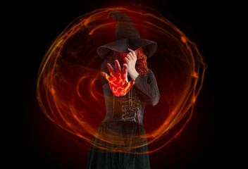 Witch woman witchcrafting, magician girl with red hair, dressed in Halloween attire and conical hat...