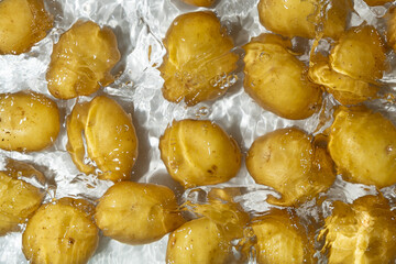 Fresh Organic Potatoes Immersed In Water With Splashing Effect.